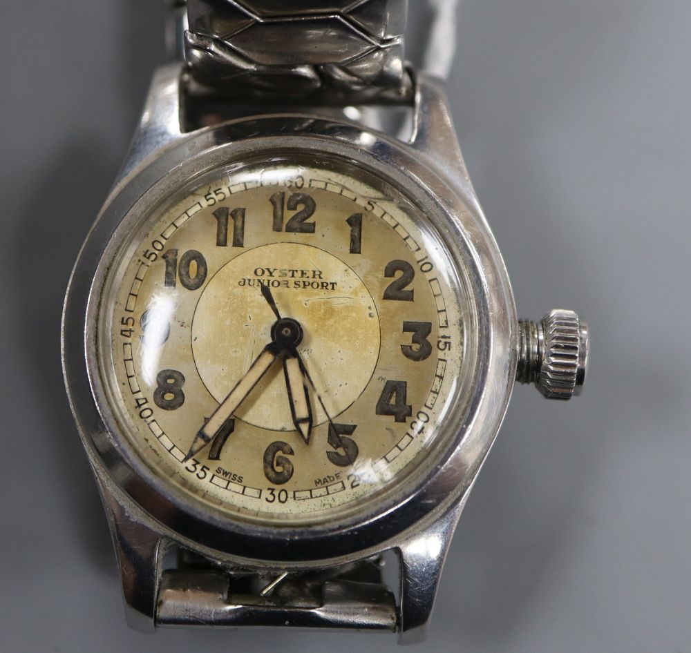 A boys size 1940s stainless steel Oyster Junior Sport manual wind wrist watch, on associated bracelet.